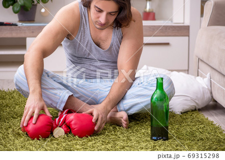 Male ex-champion boxer suffering from alcoholism at home Male ex-champion boxer suffering from alcoholism at home 69315298