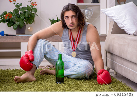 Male ex-champion boxer suffering from alcoholism at home Male ex-champion boxer suffering from alcoholism at home 69315408