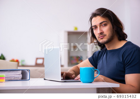Young man employee working from house Young man employee working from house 69315432