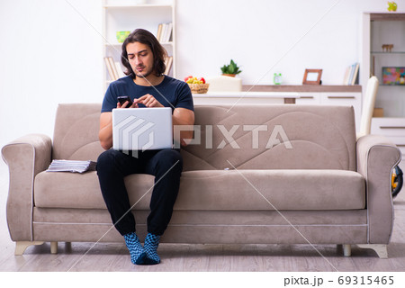 Young man employee working from house 69315465