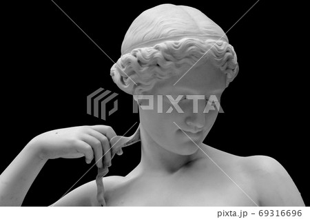 White marble sculpture head of young woman. Statue of sensual renaissance art era naked woman in circlet antique style isolated on black background 69316696
