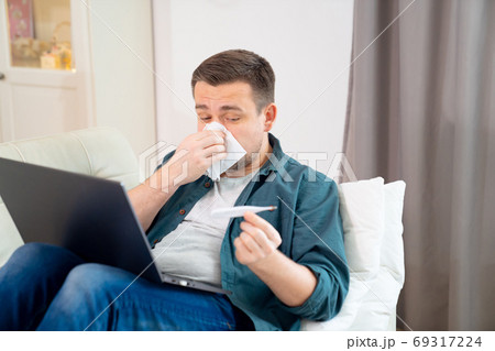 blogger is sick, measures temperature and work blogger is sick, measures temperature and work 69317224