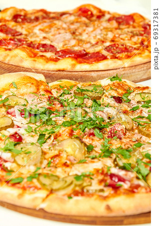 Fresh pizza with bacon, pickles and cheese on a Fresh pizza with bacon, pickles and cheese on a 69317381