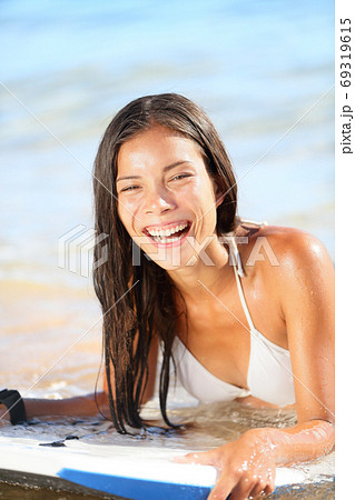 Water sport fun - beach woman bodyboarding surfing on bodyboard or boogieboard. 69319615