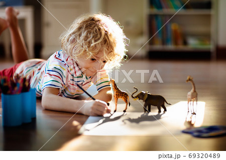 Little boy shadow drawing animals. 69320489