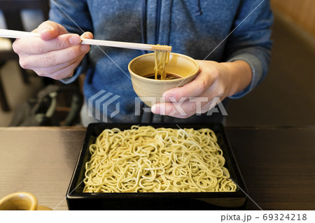 Woman enjoying Japanese soba noodle 69324218