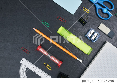 back to school, school supplies lying parallel on black chalkboard, copy space, top view, close up 69324296
