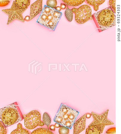 golden christmas decoration on pastel pink background, copyspace, layout 69324303