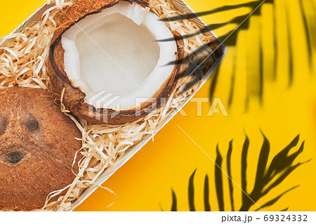 in a box coconut on a yellow background isolate, copyspace, layout 69324332
