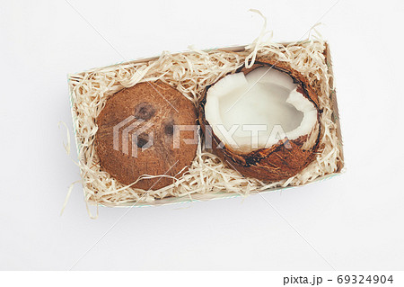 coconuts in a box on a white background isolate, copy space, flatley 69324904