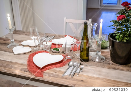Valentines day dinner setting romantic love for two wooden table red heart shape candle light with roses 69325050