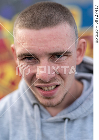 A bully guy in a light sports jacket with a hood A bully guy in a light sports jacket with a hood 69327417