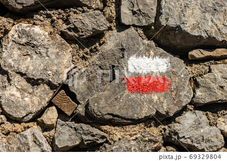 Red and White Trail Sign on a Stone Wall - Liguria Italy 69329804