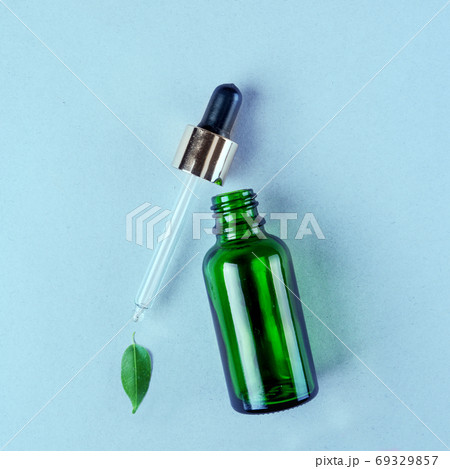 Bottle with pipette and herbal ingredients, natural cosmetics concept 69329857