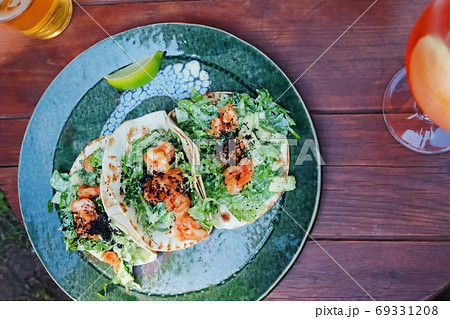 Tacos with shrimps, avocado and green salad Tacos with shrimps, avocado and green salad 69331208