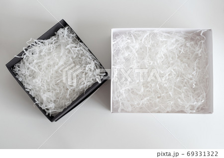 Opened gift boxes with decorative straw, filler, shavings. paper box for your product placement or montage. Presents wrapping. Top view, flat lay 69331322
