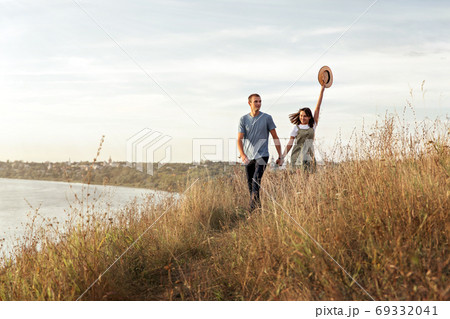 Young girl with her boyfriend on a walk outside the city. 69332041