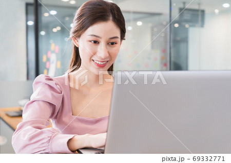 portrait of young beautiful asian business woman in casual pink t-shirt in the office,typing on laptop,Smile and have fun at work,Charming modern secretary female with a cheerful while working. portrait of young beautiful asian business woman in casual pink t-shirt in the office,typing on laptop,Smile and have fun at work,Charming modern secretary female with a cheerful while working. 69332771