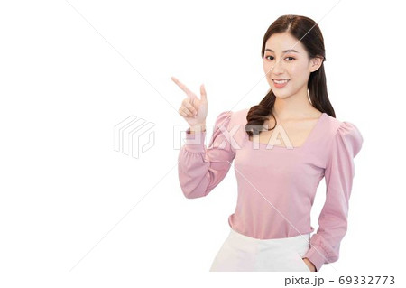 portrait of young beautiful asian business woman in casual pink t-shirt point her fingers to an empty space on the side isolated on white background,cheerful,smiling ,Charming female looking at camera 69332773