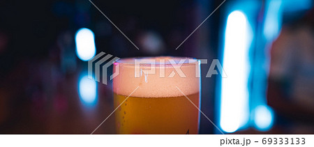 Beer poured into glasses in the bar at night. Beer poured into glasses in the bar at night. 69333133