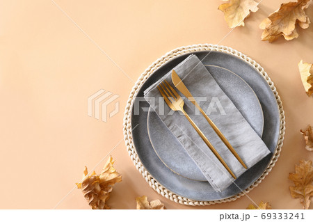 Fall table setting with autumn oak leaves  69333241
