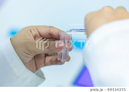 Sample analysis using Spectrophotometer for lab experiments. Sample analysis using Spectrophotometer for lab experiments. 69334355