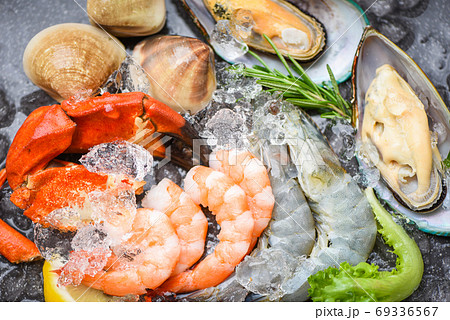 Fresh raw seafood buffet with lemon rosemary ingredients herb an 69336567