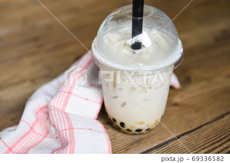 Taiwan milk tea - Bubble milk tea in glass on the wooden table Taiwan milk tea - Bubble milk tea in glass on the wooden table 69336582