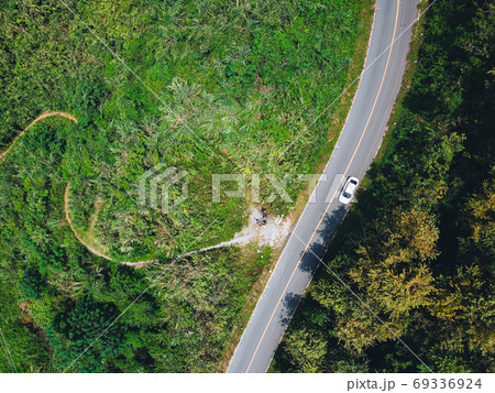 Road on the ridge A long road on a green mountain in asia 69336924