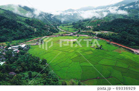The village is surrounded by mountains and green rice fields in The village is surrounded by mountains and green rice fields in 69336929