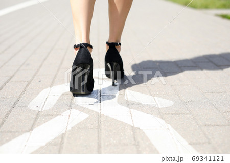 Lady walking on footpath Lady walking on footpath 69341121