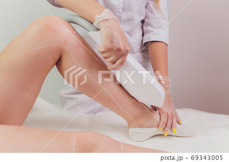 Laser hair removal on ladies legs. Intentional shallow depth of field. 69343005
