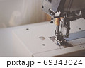 Industrial flat-seam sewing machine. Soft focus 69343024