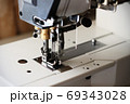 Industrial flat-seam sewing machine. Soft focus 69343028