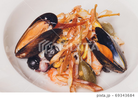 Delicious Mediterranean style tomato seafood soup with a variety of mixed seafood. Delicious Mediterranean style tomato seafood soup with a variety of mixed seafood. 69343684