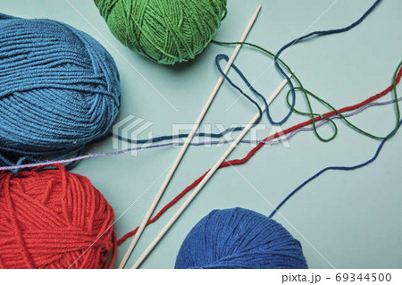 Group of various yarn balls and knitting needles closeup Group of various yarn balls and knitting needles closeup 69344500