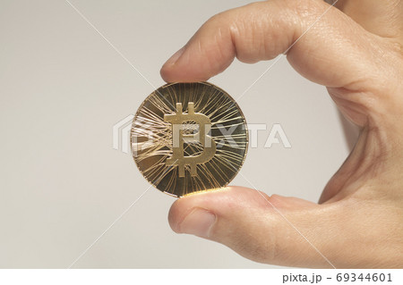 Golden Bitcoin coin crypto currency holding hand Golden Bitcoin coin crypto currency holding hand 69344601