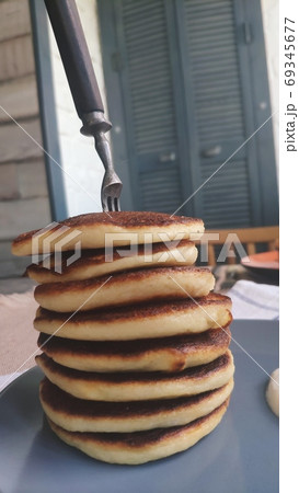 Plate with stack of homemade pancakes and sour cream on wooden table, selective focus 69345677