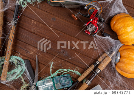 Fishing tacles on wooden background in Halloween designe with sp Fishing tacles on wooden background in Halloween designe with sp 69345772