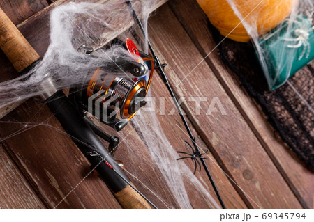 Fishing tacles on wooden background in Halloween designe with sp Fishing tacles on wooden background in Halloween designe with sp 69345794