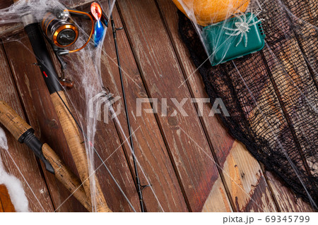 Fishing tacles on wooden background in Halloween designe with sp 69345799