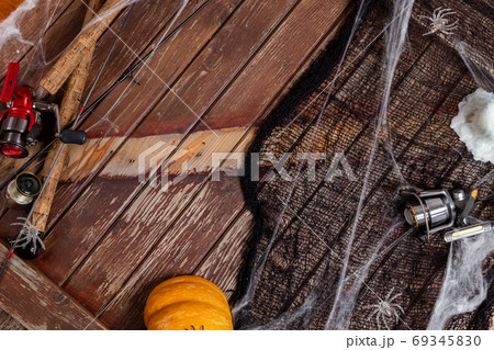 Fishing tacles on wooden background in Halloween designe with sp Fishing tacles on wooden background in Halloween designe with sp 69345830