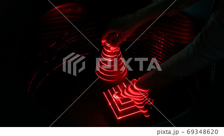 Optical illusion with red lasers, woman hand and geometric objects 69348620