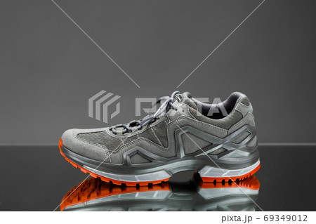 trekking sneaker with red sole, gray background trekking sneaker with red sole, gray background 69349012