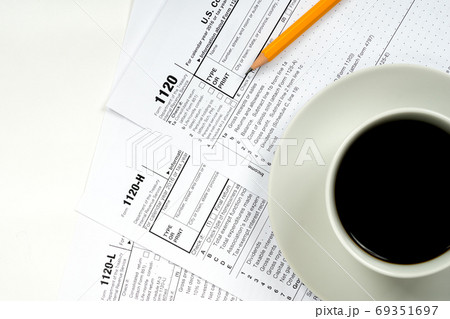 1120 tax forms top view with coffee cup and pencil 1120 tax forms top view with coffee cup and pencil 69351697