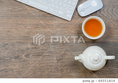 office table with computer and tea, workplace concept office table with computer and tea, workplace concept 69351814