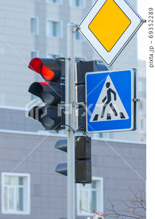 red traffic light, pedestrian crosswalk and main road traffic signs 69352289