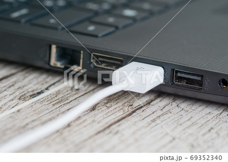 Plugged white USB cable, empty HDMI and network sockets 69352340