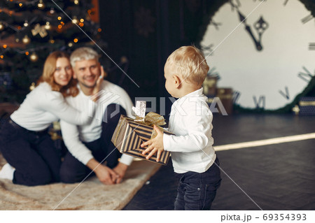 Family with little son at home near christmas tree 69354393