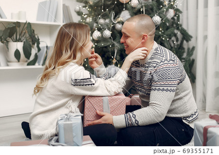 Couple spend time at home with christmas decorations 69355171